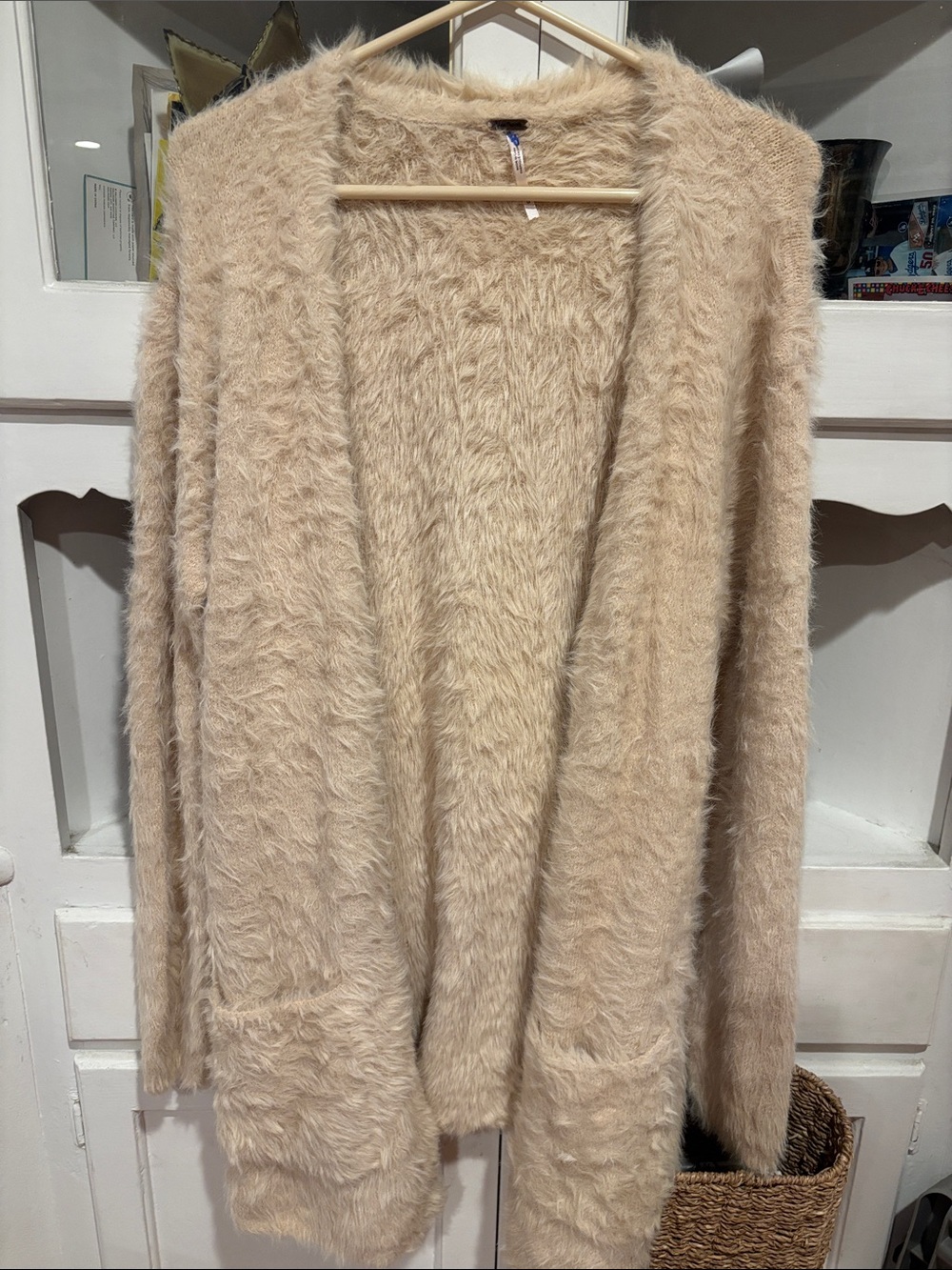 Free People faux fur open front cardigan in cream color.